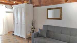 a living room with a couch and a mirror at Dreamy Loft apartment Lixouri in Lixouri