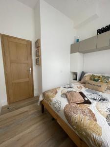 a bedroom with a bed and a wooden door at Port de carry le rouet in Carry-le-Rouet