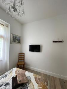 a bedroom with a bed and a tv on a wall at Port de carry le rouet in Carry-le-Rouet