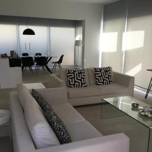 a living room with a couch and a table at Katikies Grand - Superior Villa Adults Only in Pissouri