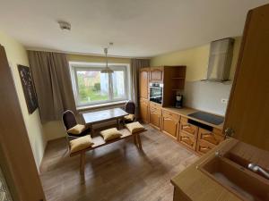 a room with a kitchen with a table and a sink at Ferienwohnung Stadthaus Cham in Cham