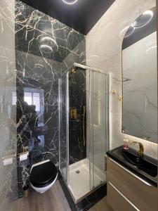 a bathroom with a shower with a toilet and a sink at Port de carry le rouet in Carry-le-Rouet +28 photos