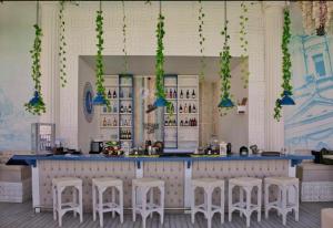 a bar with white stools and a blue counter at selena bay resort in El Gouna +23 photos