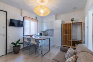 a kitchen and a living room with a table and a couch at La Casina in Carrara