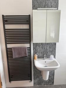 a bathroom with a sink and a mirror at The Clara, Ballycastle in Ballycastle +39 photos