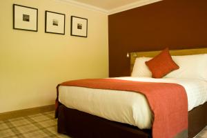 A bed or beds in a room at The Inn on Loch Lomond 