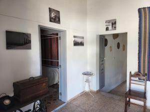 a room with white walls and a door and a room with a bed at Baleizão AL in Baleizão