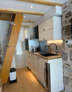 a kitchen with a sink and a counter top at Little House Komiza in Komiža