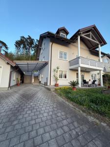 a large house with a driveway in front of it at Residenz Göttersitz in Furth im Wald