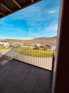 a balcony with a fence and a view of a city at Schalls Bed and Breakfast in Dettingen an der Erms +19 photos
