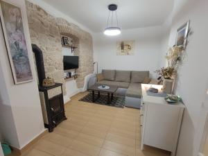 a living room with a couch and a table at Adria Pearl Appartments in Vrsar
