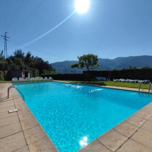 a large swimming pool with blue water at Verde Pinho in Geres