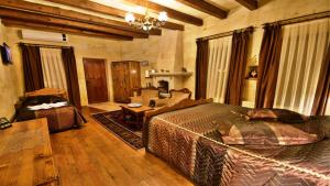 a large bedroom with a large bed and a table at Harman Cave Hotel in Göreme