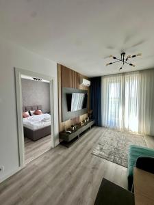 a bedroom with a bed and a large mirror at The Sea Escape Apartment in Constanţa