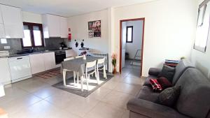 a living room and kitchen with a couch and a table at Casa da Laija - Vistas rio, campo e montanha in Cova +54 photos