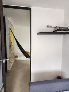 a sliding glass door in a room with a hallway at Habitación con sofacama - apto compartido in Envigado