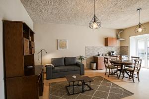 a living room and kitchen with a couch and a table at Casa Pinheiro in Pinheiro de Coja