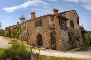 an old brick building with a street light in front of it at Due Piani in Barberino di Val dʼElsa