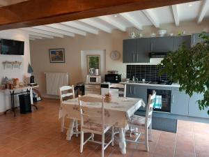 a kitchen and dining room with a table and chairs at Chambres D'Hôtes Saint Jean in Saint-Jean-de-Blaignac