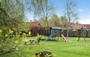 a yard with a playground with slides and a table at 3 Bedroom Cozy Home In Rørvig in Rørvig +9 photos
