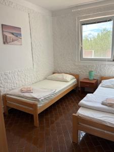 two twin beds in a room with a window at Vila Kula in Nin +61 photos