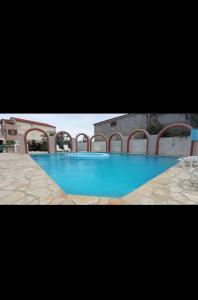a large blue swimming pool in a building at Vila Kula in Nin