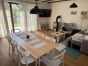a living room with a large wooden table and chairs at Chalupa - Vinařství Popela in Perná