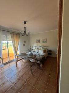 a living room with a table and a bed and a window at La Casa del Olivo en Montserrat - Valencia in Valencia