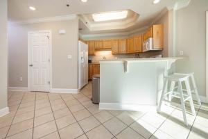 a kitchen with wooden cabinets and a white counter top at Lighthouse on the Bay 2109 condo in Orange Beach