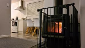 a living room with a fire in a fireplace at Hillcrest Hideaway in Rotorua