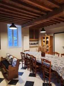 a kitchen and dining room with a table and chairs at Chambres d'hôtes Ferme LAPINE in Arthez-dʼAsson