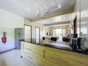a kitchen with a counter top with a refrigerator at Residence Acacia in Port Louis