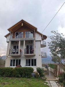 a large white house with a balcony at Farm-Sarf Libohova in Libohovë