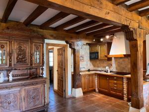 a kitchen with wooden cabinets and a large island at Apartamentos Villa Julieta in Ruente