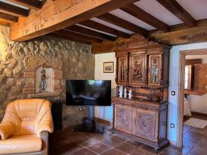 a large wooden entertainment center in a living room at Apartamentos Villa Julieta in Ruente