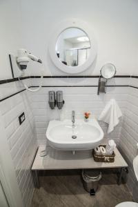 a white bathroom with a sink and a mirror at Velvet Suite in Rome +64 photos