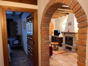 an archway leading to a living room with a fireplace at Apartamentos Villa Julieta in Ruente
