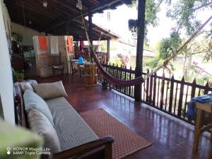 a living room with a couch on a porch at Casa lichis habitación basica in Suchitoto