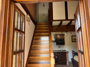 a staircase leading up to a room with a kitchen at Apartamentos Villa Julieta in Ruente