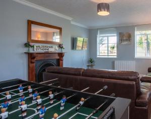 a living room with a group of lego figures on a table at 3 Bed Bungalow With Private Woods and HotTub in West Langdon