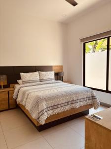 a bedroom with a large bed and a window at Casa Morfa in Uvita +57 photos
