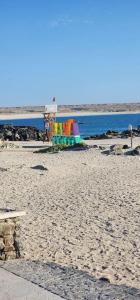 a colorful playground on a beach next to the water at Steps to the beach, comfortable in Caldera