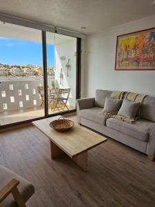 a living room with a couch and a coffee table at Steps to the beach, comfortable in Caldera