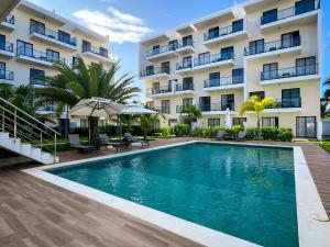 a swimming pool in front of a building at Oasis Retreat 2 Bedroom with Private Pool, Gated in Punta Cana
