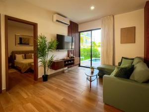 a living room with a couch and a bed and a mirror at Oasis Retreat 2 Bedroom with Private Pool, Gated in Punta Cana +26 photos