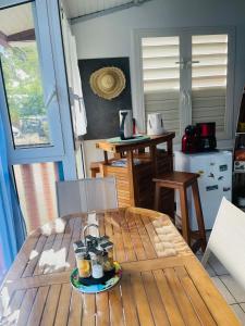 a table with a plate of food on top of it at Duplex Le Colibri 2-4p confort internet piscine plage à 5min in Sainte-Anne