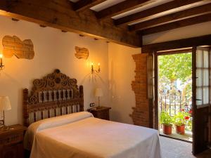 a bedroom with a large bed and a window at Apartamentos Villa Julieta in Ruente
