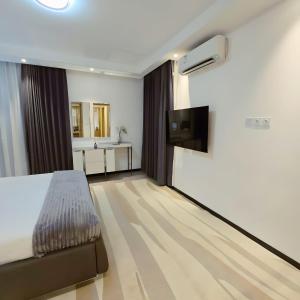 Ένα ή περισσότερα κρεβάτια σε δωμάτιο στο Gracey Concierge Apartments - Avenue Uvira