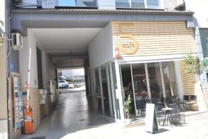 a store with a sign on the side of a building at city spot in Ioannina