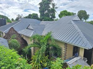 a house with a metal roof on top of it at Mount Zion Guest House, Mtwapa Mtomondoni in Mombasa